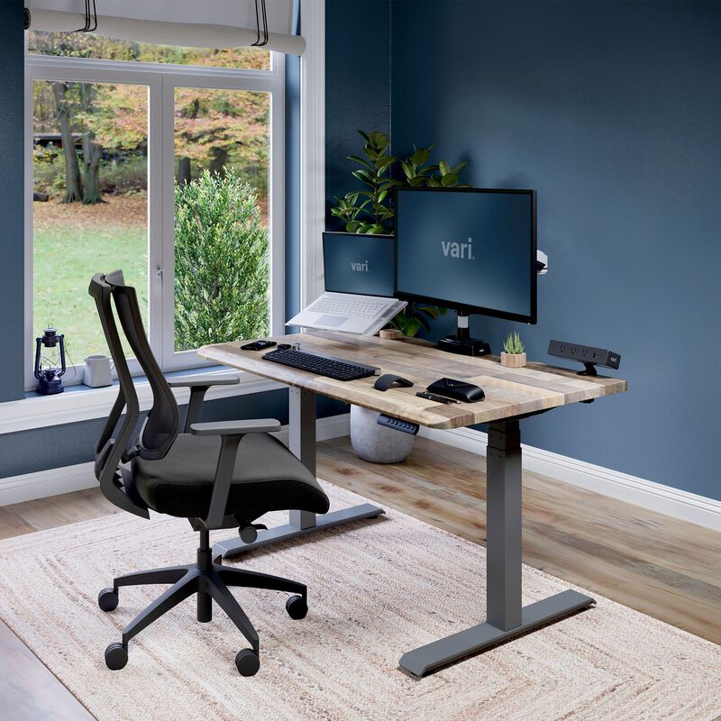 Electric Standing Desk with ComfortEdge in 48x30 Reclaimed Wood in lowered position at home image number null
